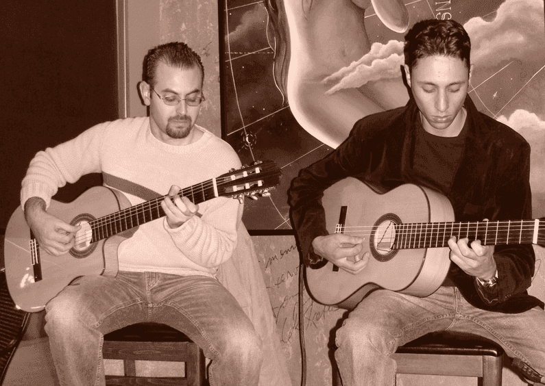 Photo of Radouane and Simeon playing guitar